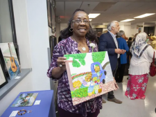 An artist participating in the 2019 JASA Art Show showcases her work